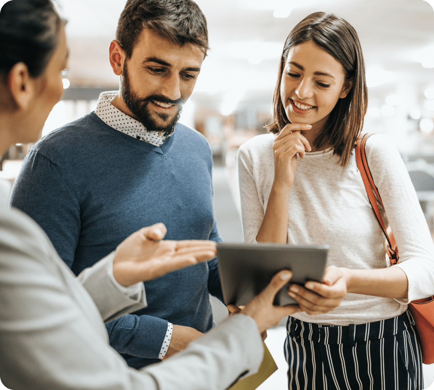 three people looking into tablet